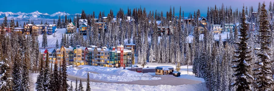 The softly glowing lights against the vibrant colors of the Fire Light Lodge as dusk settles over Silver Star Mountain.