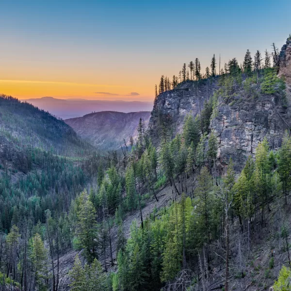 A slow, summer sun sets over Myra Canyon and sets the sky afire. This spectacular part of Kelowna is rich in history and breathtaking landscape that is synonymous with the Okanagan area.