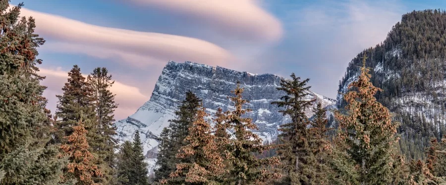 Part of the Rocky Mountain Range, a frozen and barren rockface in Banff, Alberta.