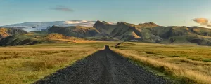 A picturesque winding road through the impressive natural terrain of Iceland.